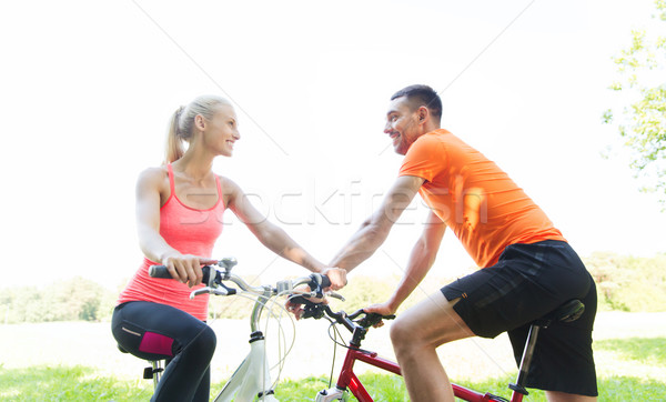 Stock photo: happy couple riding bicycle outdoors