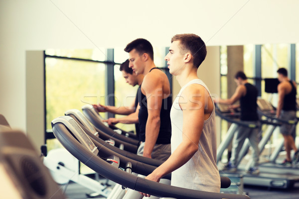 Grup erkekler egzersiz ayak değirmeni spor salonu spor Stok fotoğraf © dolgachov
