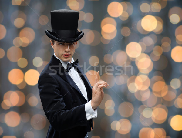 magician in top hat pointing finger up Stock photo © dolgachov