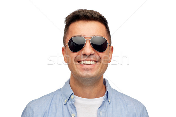 face of smiling man in shirt and sunglasses Stock photo © dolgachov