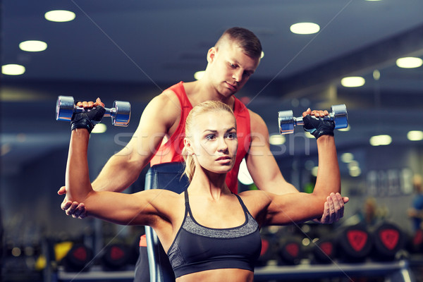 man and woman with dumbbells in gym Stock photo © dolgachov
