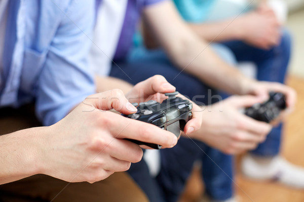 close up of friends playing video games at home Stock photo © dolgachov