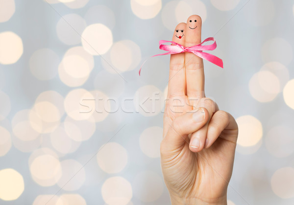 close up of two fingers tied by pink bow knot Stock photo © dolgachov