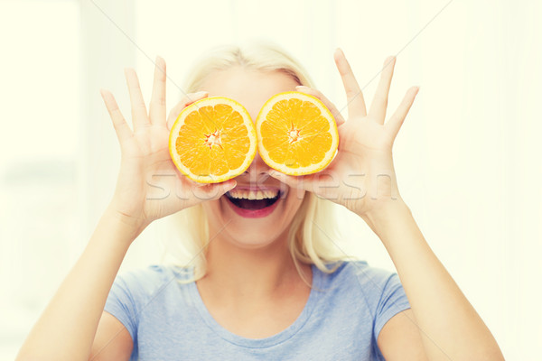 happy woman having fun covering eyes with orange Stock photo © dolgachov