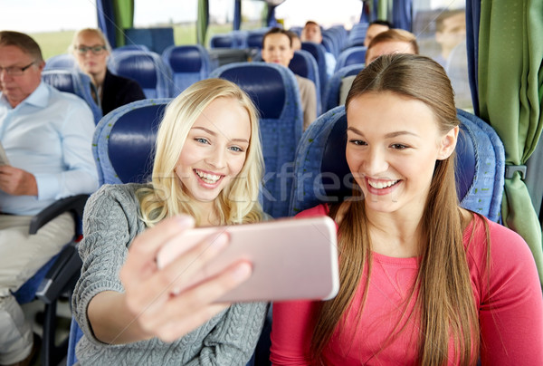 women taking selfie by smartphone in travel bus Stock photo © dolgachov