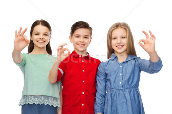 Vidám fiú lány mutat ok kézjel gyermekkor Stock fotó © dolgachov