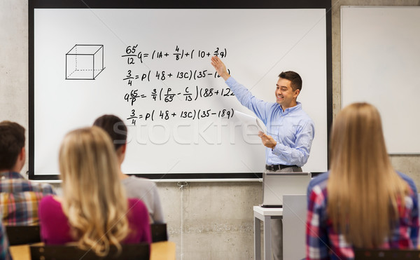 group of students and happy teacher at white board Stock photo © dolgachov