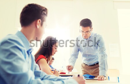 group of students and teacher at school classroom Stock photo © dolgachov