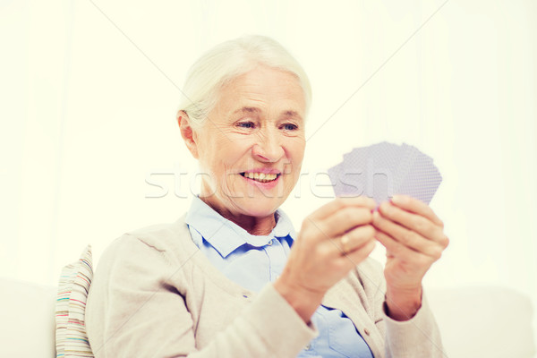 Feliz senior mulher cartas de jogar casa idade Foto stock © dolgachov