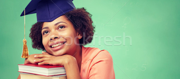 happy african bachelor girl with books at school Stock photo © dolgachov