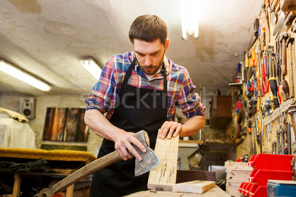 carpenter with ax and board working at workshop Stock photo © dolgachov