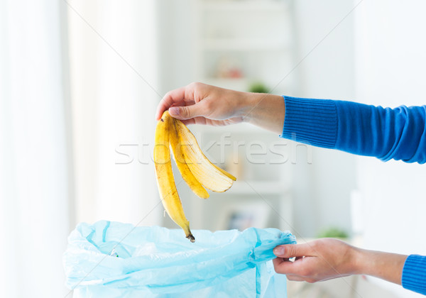 close up of hand putting food waste to rubbish bag Stock photo © dolgachov