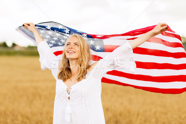 happy woman with american flag on cereal field Stock photo © dolgachov