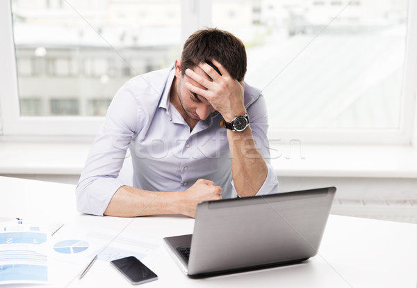 businessman with laptop and papers in office Stock photo © dolgachov