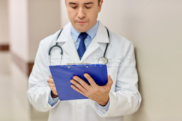 Stock photo: close up of doctor with clipboard at hospital