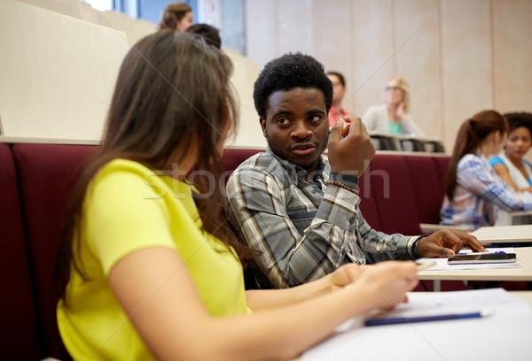 Stock photo: group of students with notebooks at lecture hall