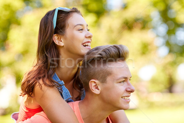 happy teenage couple having fun at summer park Stock photo © dolgachov