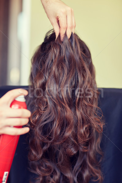 stylist with hair spray making hairdo at salon Stock photo © dolgachov