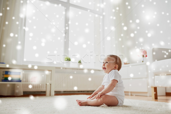 happy baby boy or girl sitting on floor at home Stock photo © dolgachov