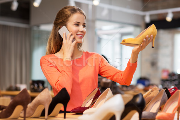 young woman calling on smartphone at shoe store Stock photo © dolgachov