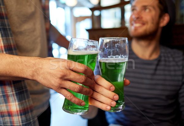 Stock photo: male friends drinking green beer at bar or pub
