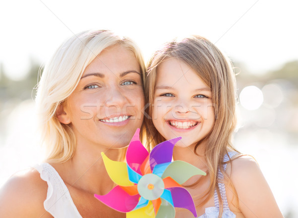 happy mother and child girl with pinwheel toy Stock photo © dolgachov