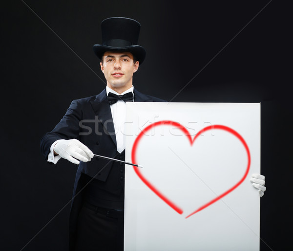 magician in top hat with magic wand showing trick Stock photo © dolgachov