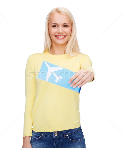 smiling young woman with airplane ticket Stock photo © dolgachov
