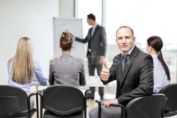 businessman with team showing thumbs up in office Stock photo © dolgachov