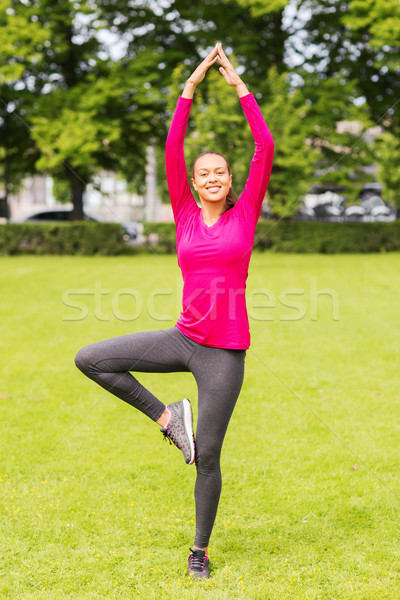 smiling woman exercising outdoors Stock photo © dolgachov