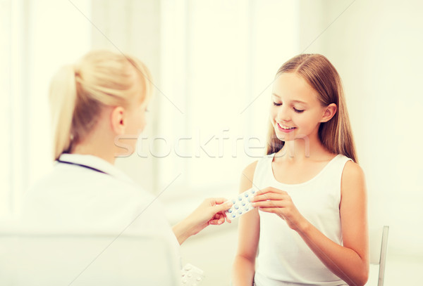 doctor giving tablets to child in hospital Stock photo © dolgachov