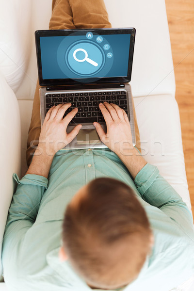 close up of man working with laptop at home Stock photo © dolgachov