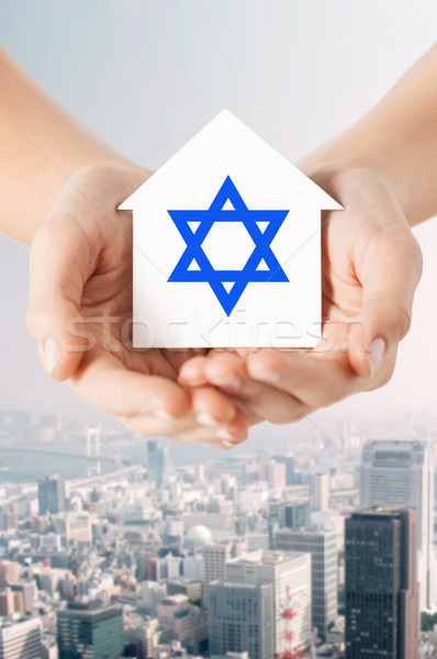 close up of hands holding house with star of david Stock photo © dolgachov