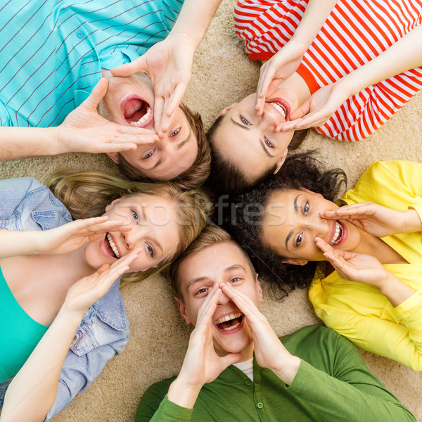 smiling people lying down on floor and screaming Stock photo © dolgachov