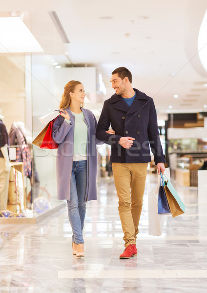 happy young couple with shopping bags in mall Stock photo © dolgachov