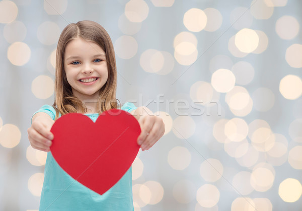 Sorridente little girl vermelho coração amor caridade Foto stock © dolgachov