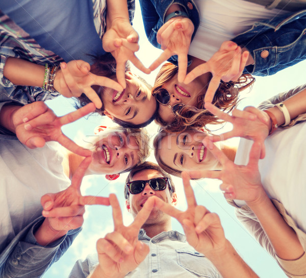 Stock photo: group of teenagers showing finger five