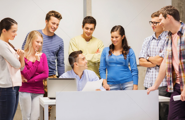 group of students and teacher with laptop Stock photo © dolgachov