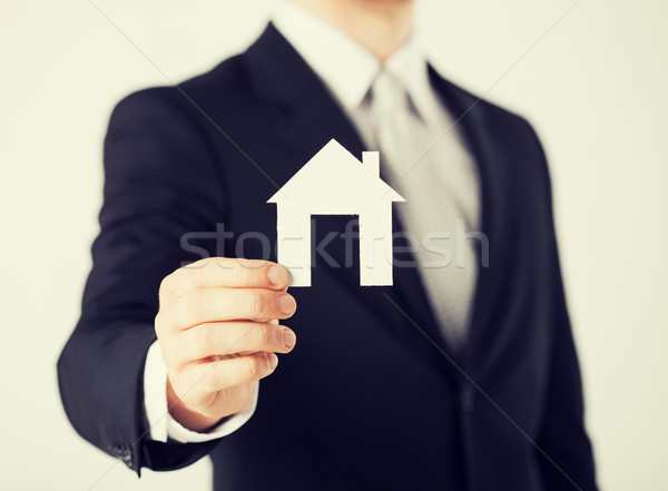 man hand holding paper house Stock photo © dolgachov