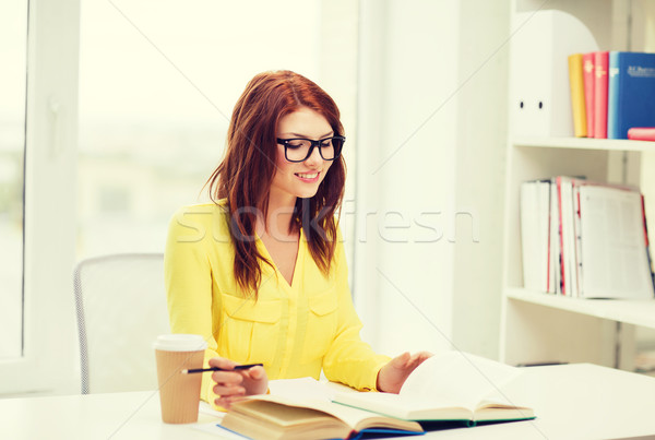 smiling student girl reading books in library Stock photo © dolgachov