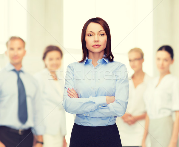 Stock photo: smiling businesswoman with crossed arms at office