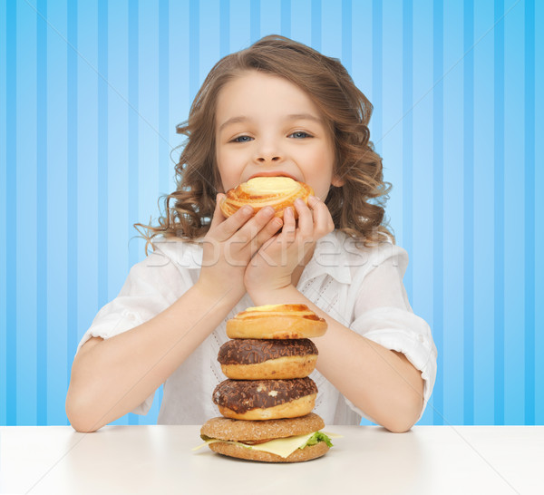happy little girl eating junk food Stock photo © dolgachov