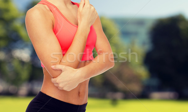 sporty woman with pain in elbow Stock photo © dolgachov