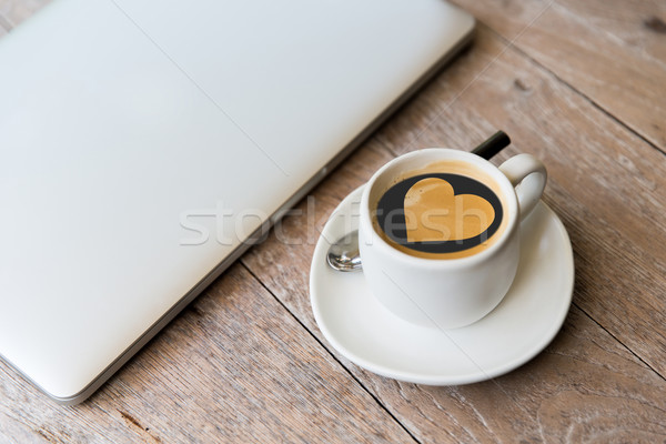 close up of laptop and coffee cup with heart shape Stock photo © dolgachov
