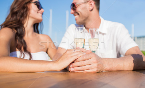 happy just married couple with champagne at cafe Stock photo © dolgachov