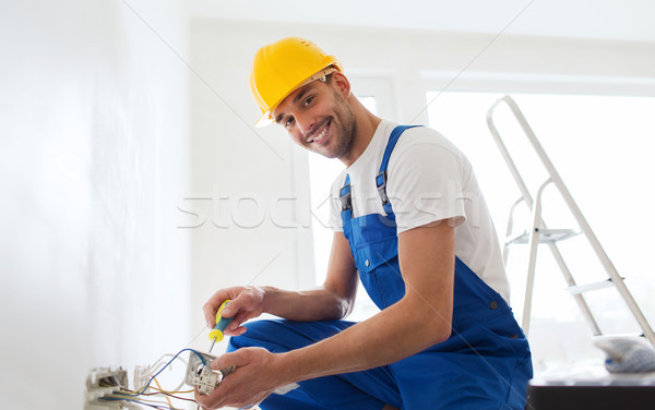 builder with tablet pc and equipment indoors Stock photo © dolgachov