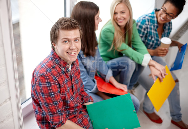 group of happy high school students or classmates Stock photo © dolgachov