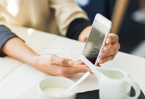 close up of women with smartphone at restaurant Stock photo © dolgachov