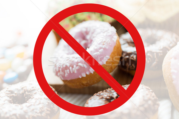 close up of glazed donuts pile behind no symbol Stock photo © dolgachov