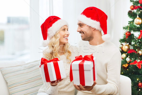 happy couple at home exchanging christmas gifts Stock photo © dolgachov